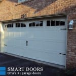 white carriage style barn garage doors installed in Woodbridge with glass inserts