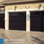 white carriage style barn garage doors installed in concord with glass inserts