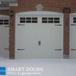 Toronto Garage door replacement featuring while carriage style doors