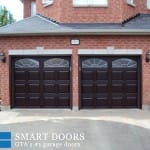 double fiberglass garage door with raised panels and glass insert installed at Richmond hill home
