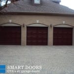 triple Raised panel fiberglass Garage door with glass insert installed by smart doors in Markham