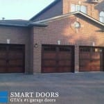 Toronto installation of red cedar wood tone double garage doors