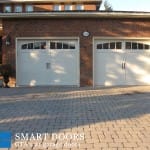 two new white Carriage style double Garage Doors installed in north york