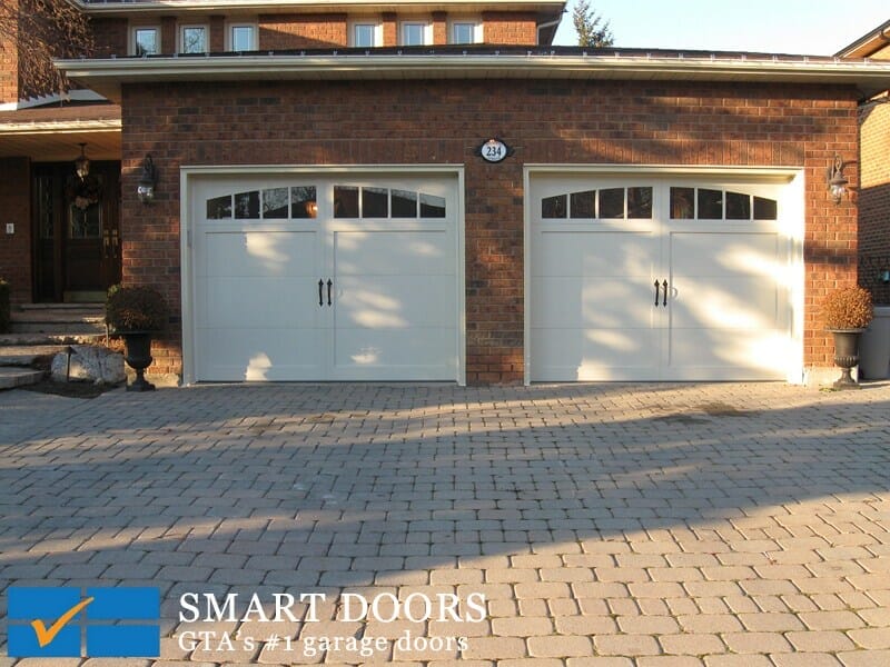 two new white Carriage style double Garage Doors installed in north york