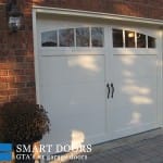 overlay panel garage doors with window insert installed in North York home