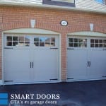Two While overlay panel garage doors with window insert installed in Markham home