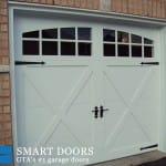 Carriage style white garage doors installed in Toronto home