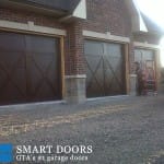 Toronto Garage door replacement project featuring barn style garage doors with window insert installed