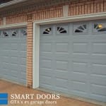 Double Raised panel Garage doors with window inserts installed in Concord home