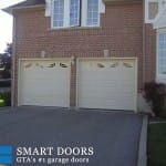 White double raised panel garage doors with window inserts installed in north York, Toronto