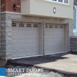 White double raised panel garage doors with window inserts installed in north York, Toronto