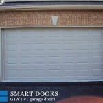 White raised panel garage door with window installed in Thornhill