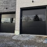 Modern Smooth Black garage door with see through panel installed in Vaughan