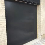 Flush black overhead garage door installed in Toronto