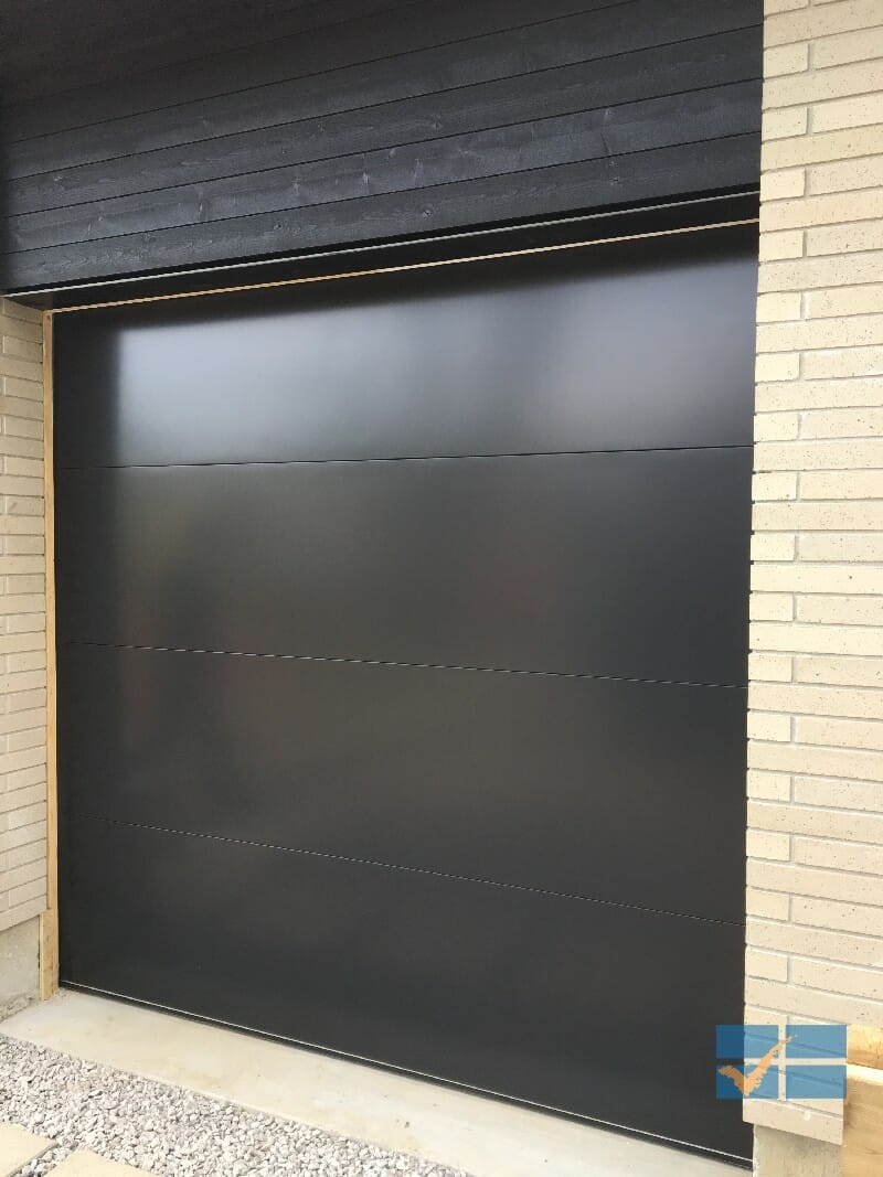 Modern Flush black overhead garage door installed in Toronto by smart doors
