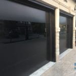 fiberglass matt black garage door with glossy glass insert installed in Maple near Toronto