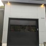 Black glass garage door with see through panel installed by smart doors toronto