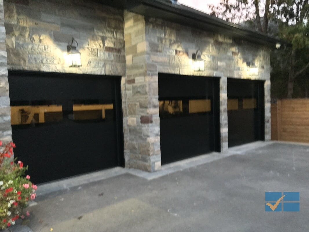 modern black fiberglass garage doors in this Toronto residence