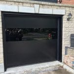 Modern black Garage Door with smooth finish and see through panel