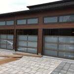 Triple Bay Custom Glass Garage Doors with wood finish installation in Toronto
