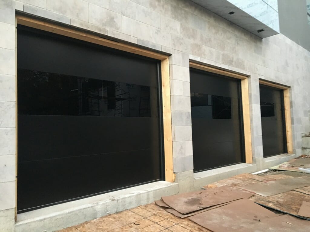 Smooth Black glossy overhead Garage Doors Installation Project in Toronto