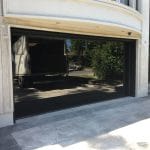 Installation featuring smooth black glass garage door installed