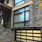 A contemporary overhead garage door has been put in a Toronto residence