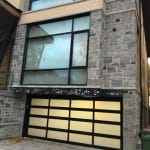 Modern Glass and aluminum overhead garage door installed in Toronto home by smart doors