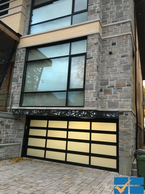 Modern Glass and aluminum overhead garage door installed in Toronto home by smart doors