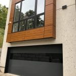 Modern Black Garage door with smooth finish and glass insert