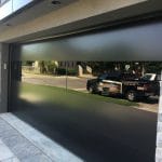 Modern Smooth Black Garage Doors with Glass-Toronto Installation